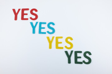 A banner with word YES that repeats four times in different colors: red, blue, yellow and green
