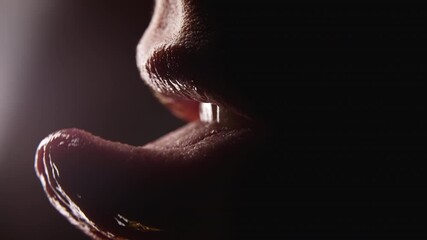 Close-up of woman's mouth. She shows her tongue seductively and licking lips with desire. Temptation, hint and flirt concept - Powered by Adobe
