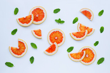High vitamin C. Juicy grapefruit slices with mint leaves on white