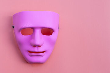 Pink face mask on pink background.