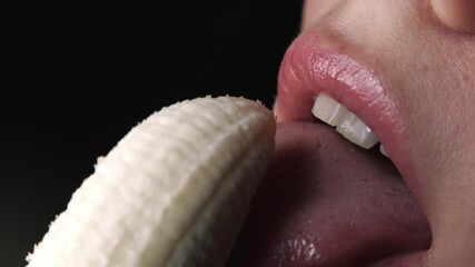 Sexy young woman seductively licking fresh banana. Macro view of lady facial expression of desire. Close-up of female mouth, sensual footage. Slow motion. - Powered by Adobe