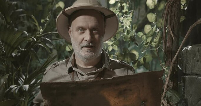 Happy adventurer exploring the jungle with a map