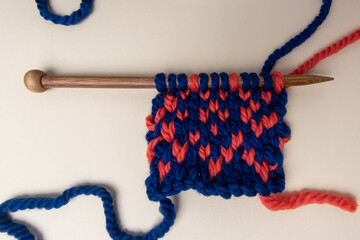 chunky knitting on wooden knitting needles with a fair isle pattern 