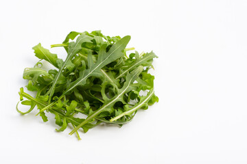 Fresh green rocket salad on white background.