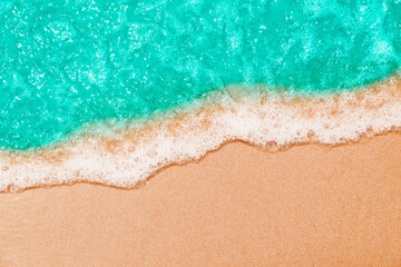 Fototapeta na wymiar Soft Blue ocean wave on sandy beach. tropical white sand With the sea at the corner.