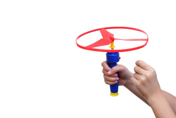 Kid's hands holding and playing toy disc helicopter isolated on white background