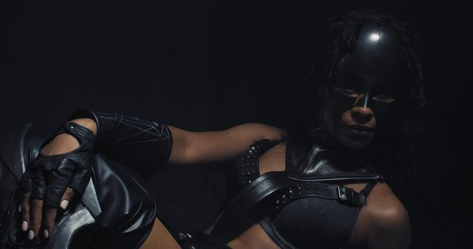 Sexy super hero, young woman in a mask is lying on the floor posing, 4k