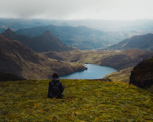 woman hiking in the mountains and watching the landscape 