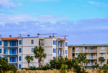 Scaffolding Cranes on Beach Condos Under Winter Sky