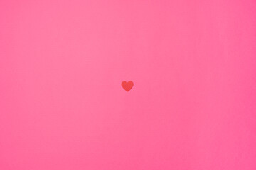 Paper red heart isolated in the center on a pink background. Symbol of love for Happy Women's,...