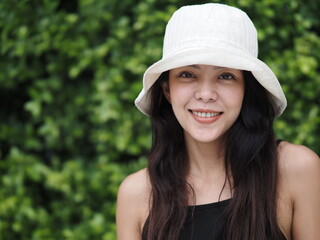 portrait of young asian woman in black dress and white hat