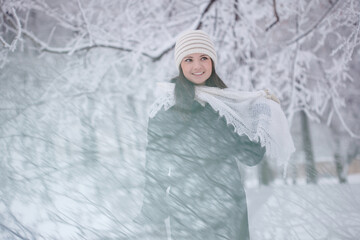 Beautiful girl  on the street in winter.  Woman outdoors against the backdrop of a magical winter landscape.