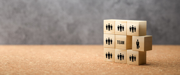 wooden cubes showing a team and the word TEAM on concrete background