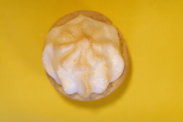 mini lemon pie on yellow background.