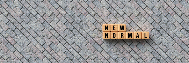 cubes with message NEW NORMAL on concrete background