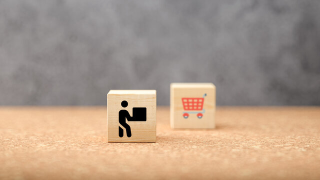 cubes with shopping icons on concrete background