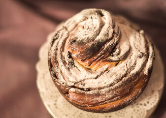 Traditional cupcake Easter cake kraffin craffin with raisins on dark purple background. homemade cake Cruffin with dried fruits. Easter decoration table. easter desert celebration. Layers of the cake