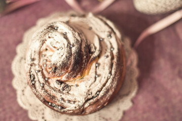 Traditional cupcake Easter cake kraffin craffin with raisins on dark purple background. homemade cake Cruffin with dried fruits. Easter decoration table. easter desert celebration. Layers of the cake