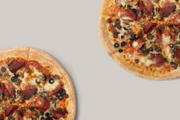 The pizzas are delicious and the ingredients are sausage, bacon and mozzarella on a brown background. can be made of backgrounds, flyers and other forms of advertising,