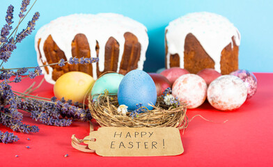 Colorful background with Easter eggs on red and blue background. Happy Easter concept. Can be used as poster, background, holiday card. Flat lay, top view, copy space. Studio Photo