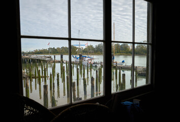 Britannia Shipyards Heritage Dock. Dock view through a window of the historic Brittania Heritage shipyard on the banks of the Fraser River in Steveston, British Columbia, Canada.

