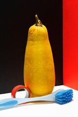 Zucchini, duct tape and brush over modern black white red background.