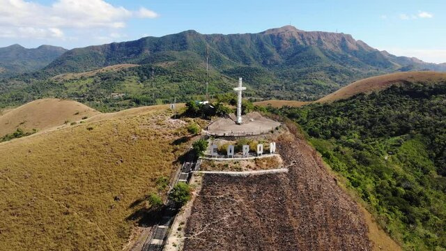 Aerial Approach Of The Catholic Cross Ontop Of Mount Tapyas That Overlooks
