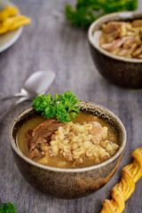 Fototapeta premium Porcini mushroom soup with potato and pearl barley.