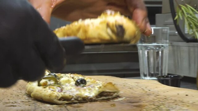 Preparing a traditional Turkish baked pide dish. Turkish pide pizza, Middle Eastern snacks. Turkish cuisine. Pide with meat filling.