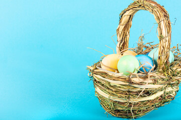 Colorful background with Easter eggs on blue background. Happy Easter concept. Can be used as poster, background, holiday card. Flat lay, top view, copy space. Studio Photo
