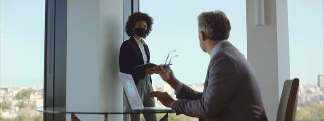 Colleagues at the modern office discussing the financial plan during COVID-19 pandemic. - Powered by Adobe