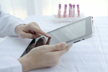 Fototapeta premium Doctor hands use a tablet, hospital lab, on the work table,Working doctor,white office of the hospital, healthcare concept