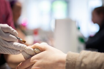 painting fake nails in nail salon