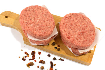 Raw beef patties for making a burger.Isolated on a white background.Selective Focus.
