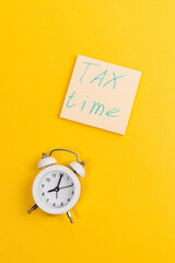 Tax time flat lay composition on yellow background. copy space. vertical photo