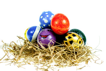 Fototapeta na wymiar Easter eggs in nest on white background