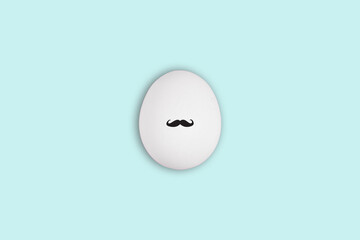 White easter egg with black gentleman mustache on blue background