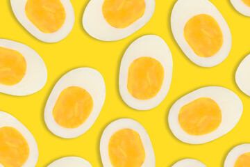 Boiled cut eggs pattern on yellow background