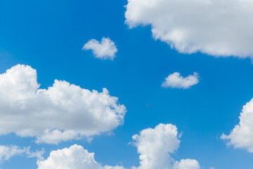 Blue clear sky with white fluffy clouds. Natural background