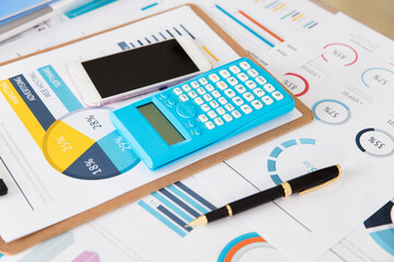 The desk was covered with financial documents and other items