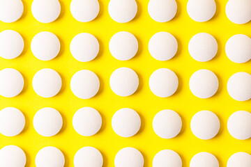 Image of a drug, pill, or remedy. On yellow background paper.