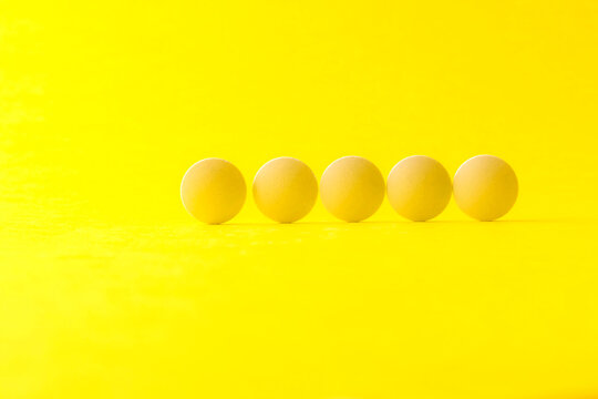 Image of a row of pills. Medicines.