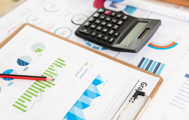 Naklejka na ściany i meble Financial information and calculator on the desk