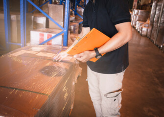 Warehouse worker holding clipboard checking order. inventory management of product. warehousing...