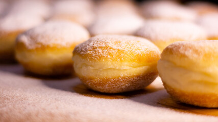 side angle close up a pile of doughnut with icing sugar in wooden table