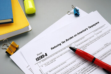 Business concept meaning Form 13285-A Reducing Tax Burden on America's Taxpayers with phrase on the sheet.