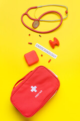 Word ENDOCRINOLOGY, thyroid gland, stethoscope and pills on color background