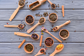 Composition with dry tea leaves on wooden background