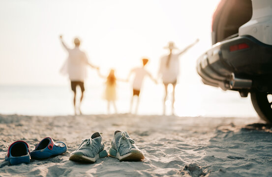 Close Up On The Shoes.Family Vacation Holiday, Happy Asian Family Running On The Beach In The Sunset. Back View Of A Happy Family On A Tropical Beach And A Car On The Side.