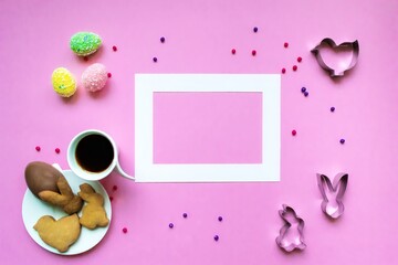Easter background. A festive composition with a frame for your text. Coffee with handmade cookies, colored eggs